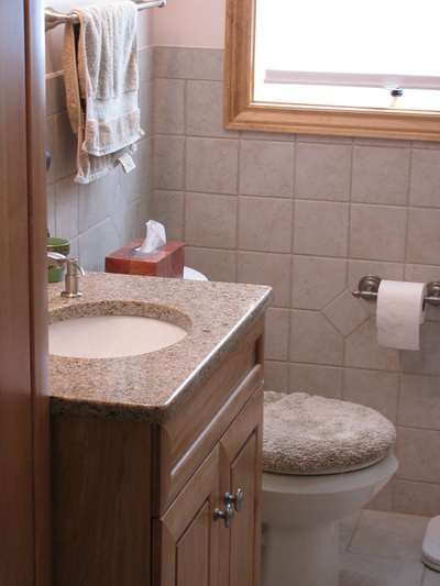 Remodeled bathroom, close view, sink/toilet side.