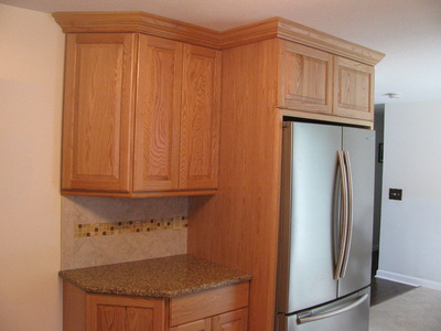 Remodeled kitchen cabinets, fridge area.